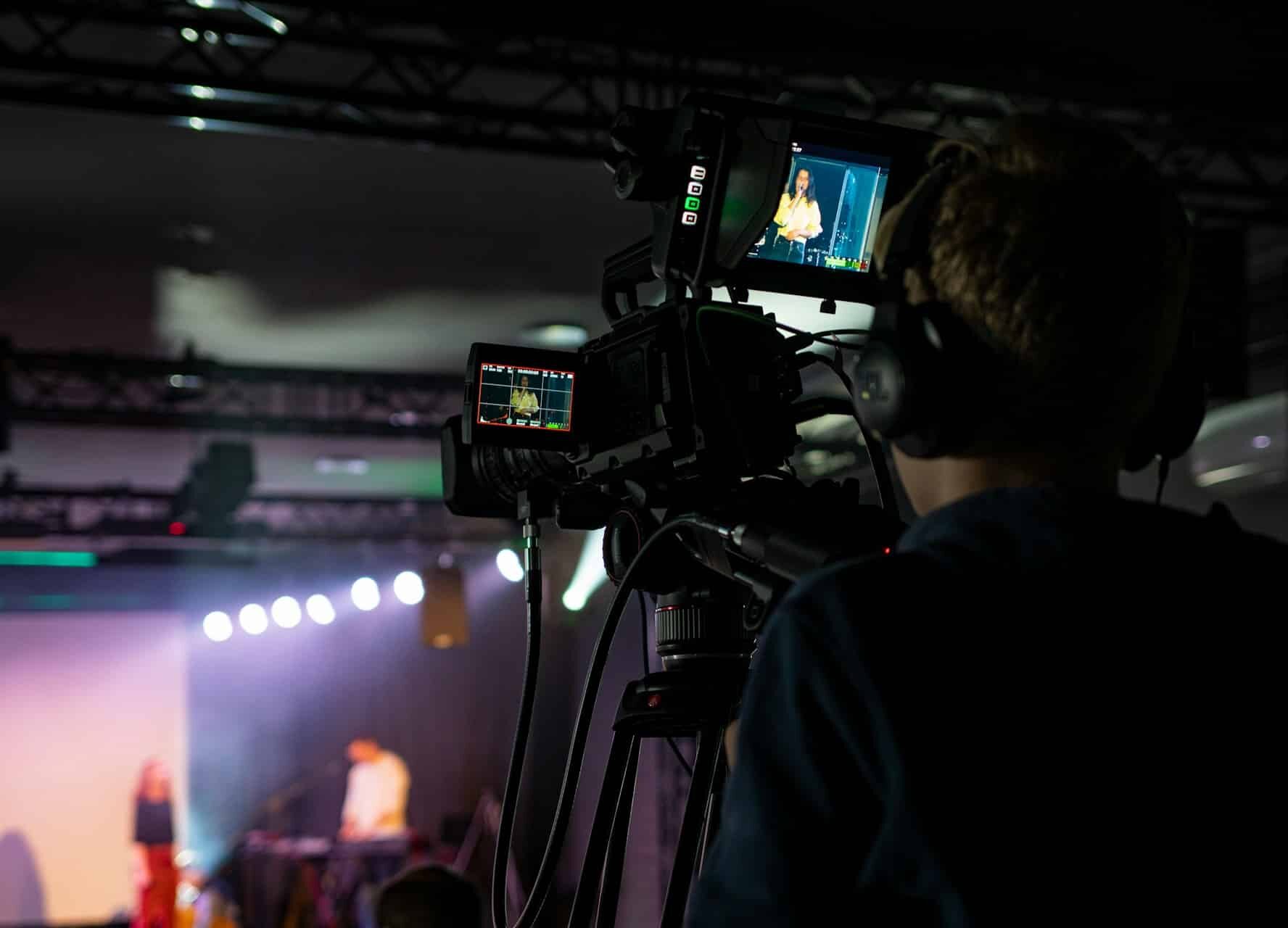 event_coverage1 Film crew working on event coverage with cameras and tripods.